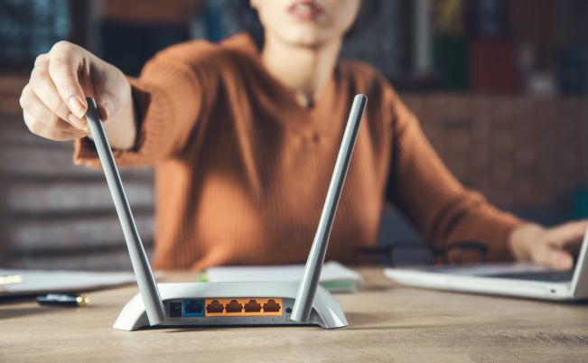 woman adjust router antennas