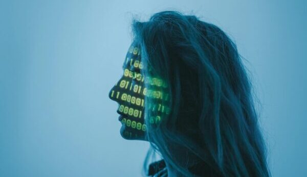 femlae coder with binary green numbers projected on face